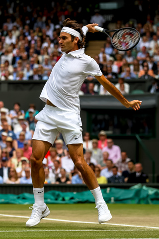 LONDON, ENGLAND - JULY 6: Roger Federer of Switzerland in action during the Gentlemens'  Singles final match against Novak Djokovic of Serbia on day thirteen of the Wimbledon Lawn Tennis Championships at the All England Lawn Tennis and Croquet Club at Wimbledon on July 6, 2014 in London, England.
